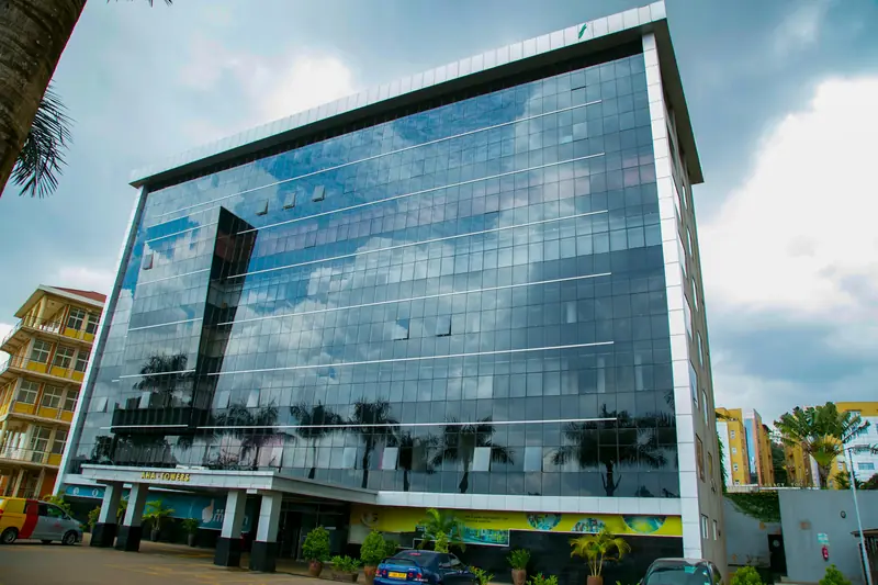 Modern glass office building in Kampala on a clear day