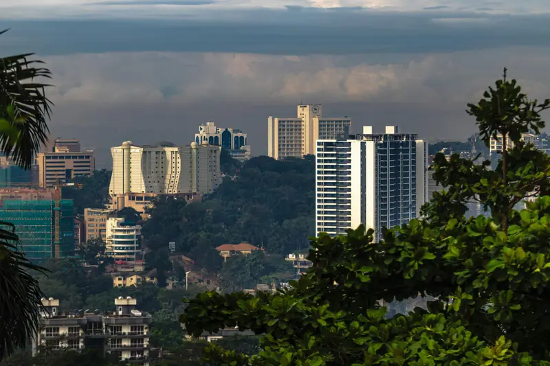 Kampala skyline with modern towers rising above green hills