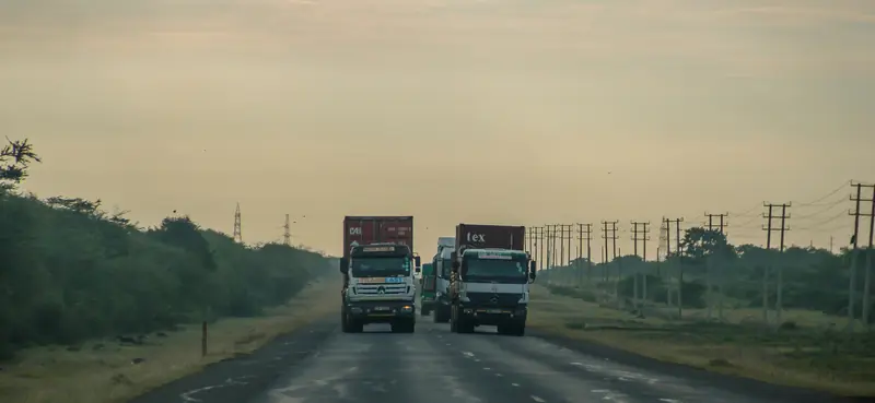 Container lorries travelling on a highway in Kenya